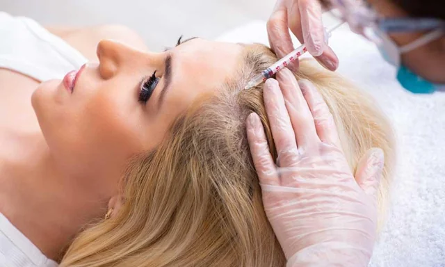 A clinician assessing the scalp during a hair-restoration procedure