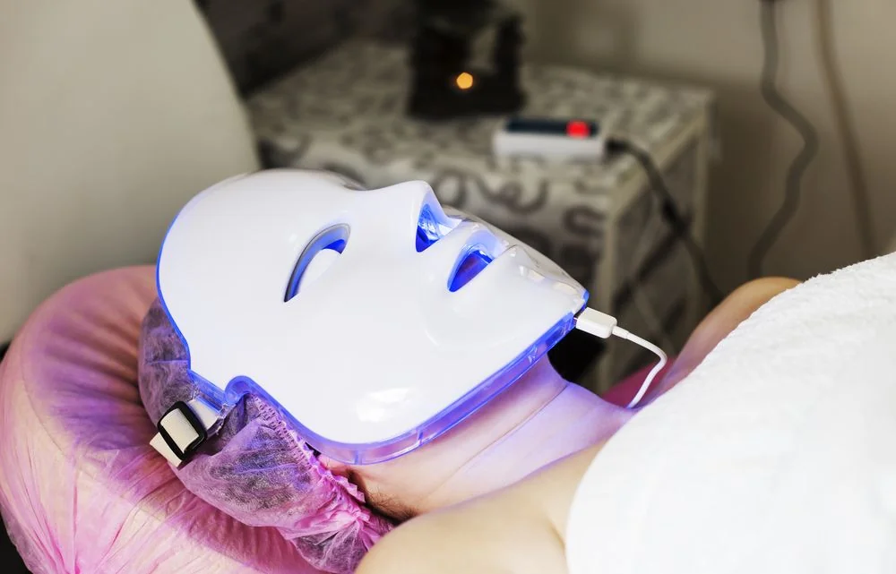 A patient receiving a light-based facial treatment