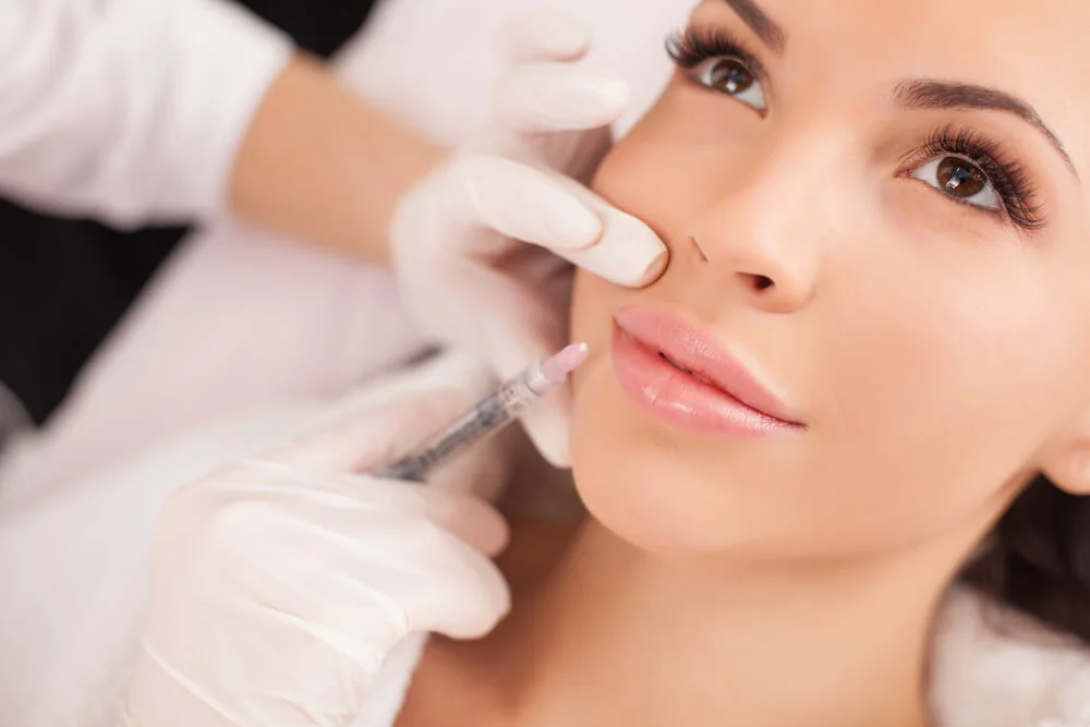 Close-up of a facial injectable procedure performed by a practitioner